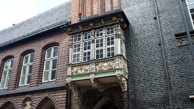 View of carved balcony, facade of the town hall, Lubeck, Germany
