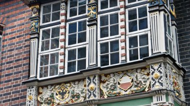 View of carved balcony, facade of the town hall, close up, Lubeck, Germany