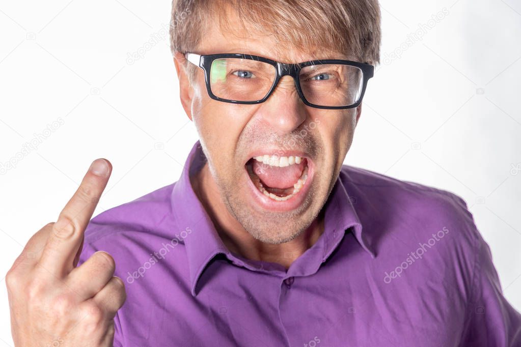 Portrait of a angry man staring at camera, shows finger and shouting over gray background