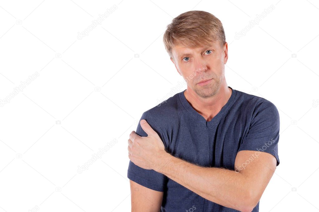 Man holding his sore shoulder trying to relieve pain