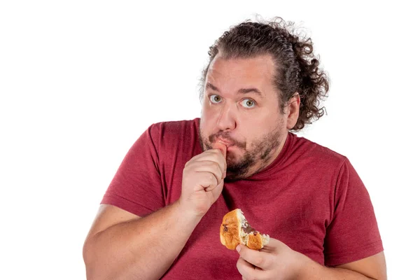Funny fat man eating croissant