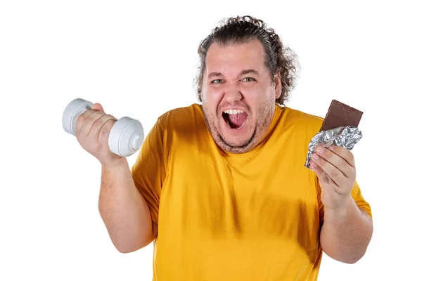 Funny fat man eating unhealthy food and trying to take exercise isolated