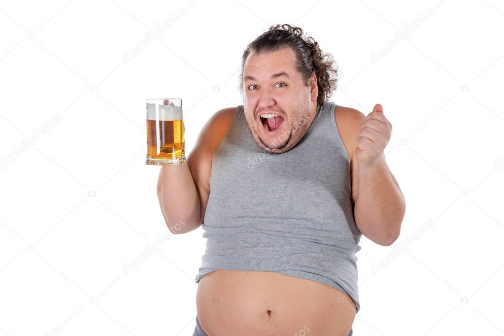 Funny fat man feeling happy and relaxed, holding fresh cold beer in his hands