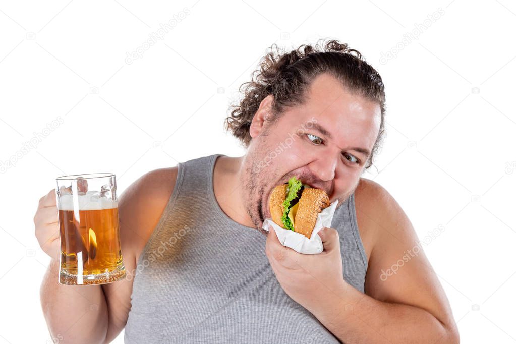 Funny fat man eating burger and drinking alcohol beverage