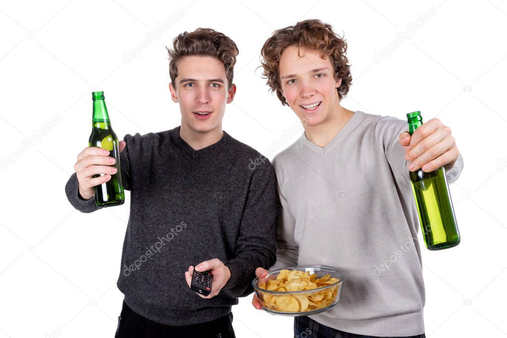 Two happy guys drinking beer and eating chips while watching football game