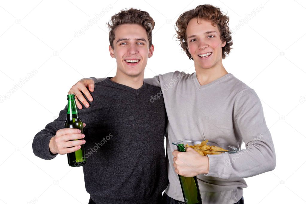 Two happy guys drinking beer and eating chips while watching football game