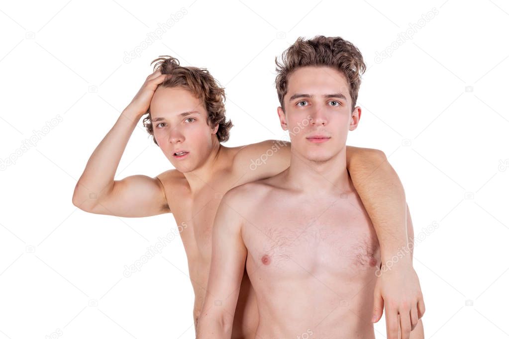 Two young sexy guys hugs on a white background. Love, passion and relationships
