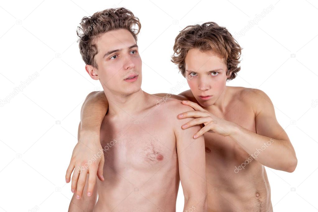 Two young sexy guys hugs on a white background. Love, passion and relationships