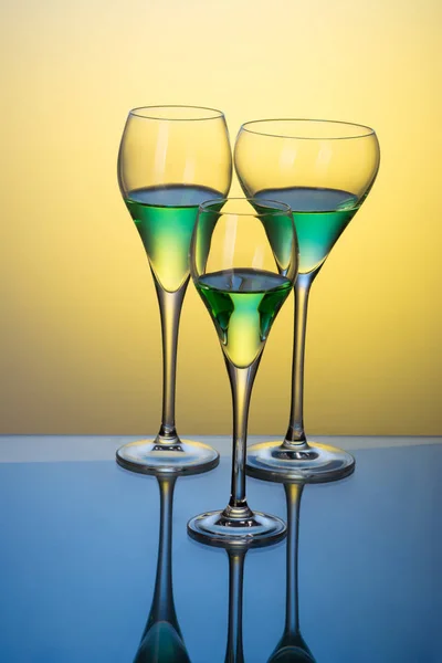 Three glasses with cocktails on a blue table — Stock Photo, Image