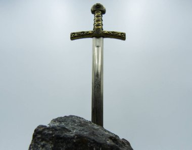 Excalibur the mythical sword in the stone of king Arthur clipart