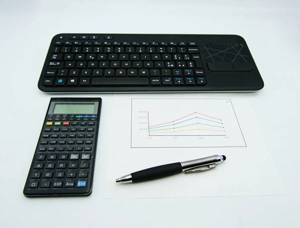 Data graphs and diagrams, pen and calculator, computer keyboard on white background