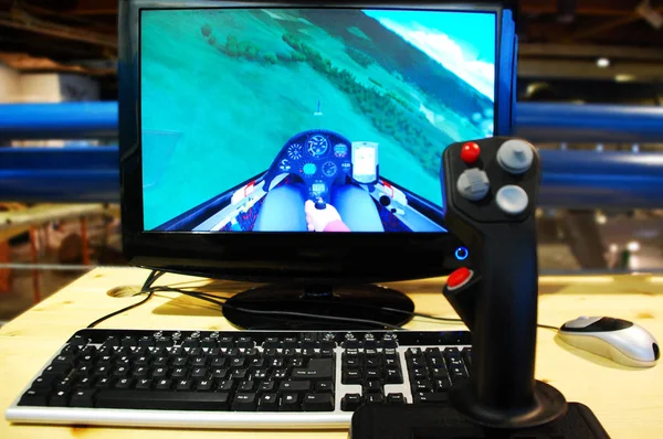 Pc flight simulator, with flight joystick, on wooden desk