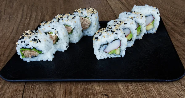 Fresh tuna and sesame uramaki sushi. Fresh exotic surimi, avocado uramaki sushi. Asian traditional food.