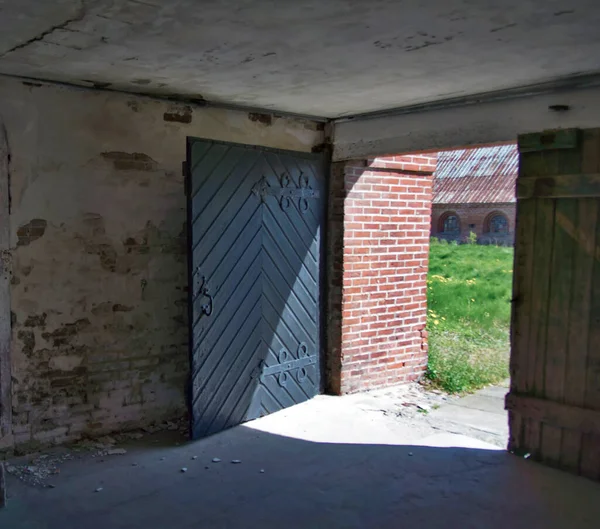 An open barn door on an old farm.