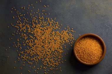 Koyu arkaplanda pişmemiş mercimek.