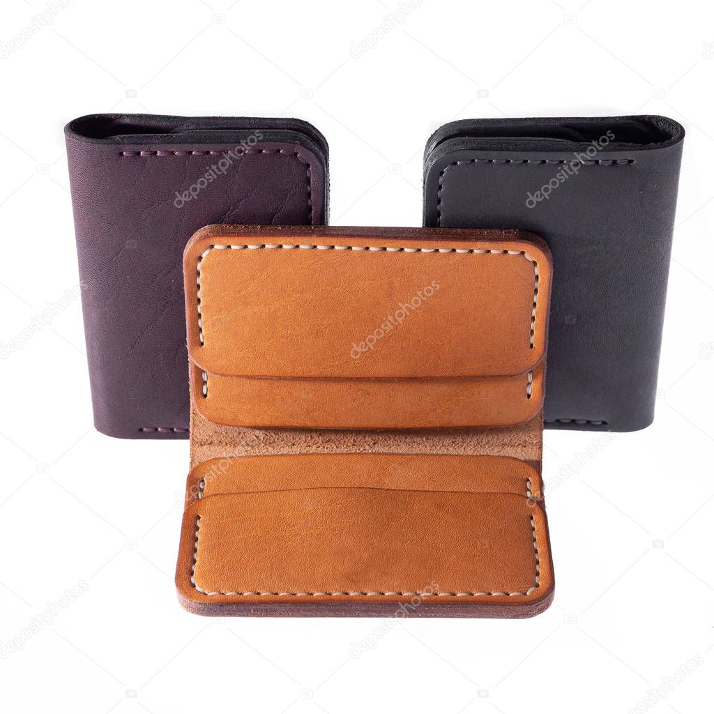 Leather accessories on a white background, wallets, coin boxes and straps, isolated