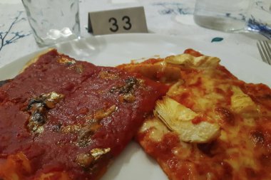 Ekşi hamurlu, tarifli ve pişirilmiş iki dilim ev yapımı pizza.