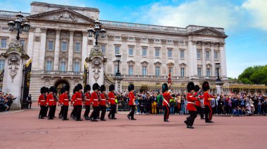 LONDON, UK - MAY 13 2018: The changing of the guard at Buckingham Palace - is a formal ceremony in which a group of soldiers is relieved of their duties by a new batch of soldiers clipart