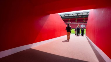 LIVERPOOL, UNITED KINGDOM - MAY 17 2018: LFC staffs and a group of its football fans take a tour in Anfield stadium, the home ground of Liverpool football club clipart