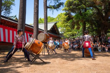 TOKYO, JAPAN - APRIL 29 2018: Unidentified group of women perform Japanese Taiko drum in Bunkyo Azalea Festival (Tsutsuji Matsuri) at Nezu Shrine clipart