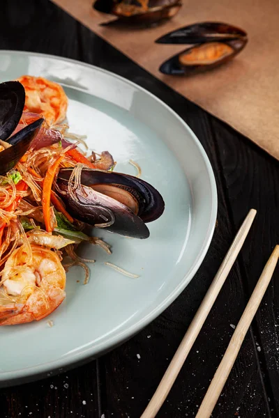 stock image Delicious close up view on Chinese noodles with mussels. Chinese cuisine, dark backround, top view food, copy space for text, selective focus. Asian fastfood.