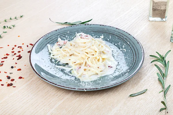 Close up view on traditional italian pasta with cherry tomato, herbs and spices on wooden background. Restaurant, food menu, recipe, cafe concept. Lifestyle with copy space. Italian cuisine.