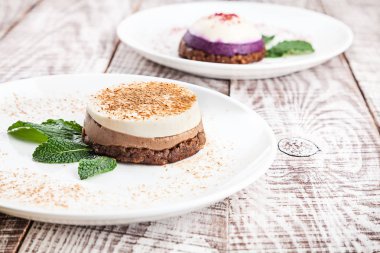 Espresso fincan ile beyaz ahşap arka planda iki Vegan ham kek üzerinde görünümü yakın. Kahvaltı için vejetaryen tatlı. Tasarım ve metin için kopya alanı ile sağlıklı gıda.