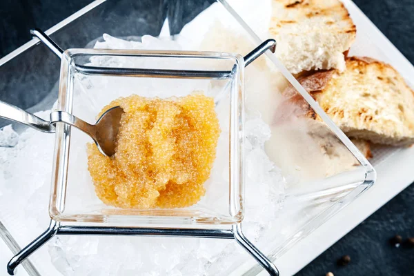 Fresh Pike caviar or roe in glass blow, served on ice. luxury food. Healthy Seafood. Copy space for design. russian cuisine