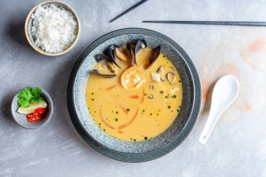 Üst görünüm tom yam pirinç kase ve limon ile servis deniz ürünleri ile. Popüler sıcak ve ekşi Tay çorbası. Kopya alanı. Düz baharatlı ve lezzetli gıda ile yatıyordu. Banner veya menü fotoğrafı. Tom yum