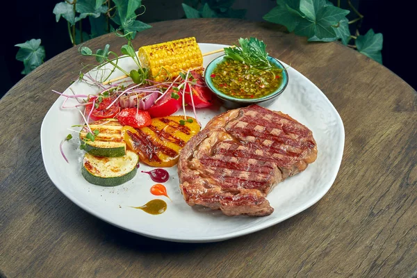 Beef Rib Eye Steak Grilled Vegetables Green Sauce White Plate — Stock Photo, Image