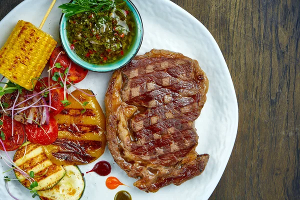 Beef Rib Eye Steak Grilled Vegetables Green Sauce White Plate — Stock Photo, Image