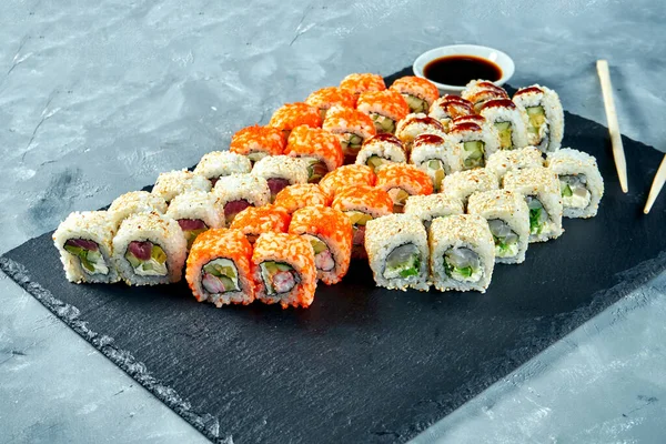 Set of traditional Japanese sushi - California rolls with eel, salmon and tuna. Close up