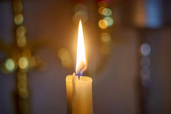 Luz de chama de vela à noite com bokeh no fundo escuro . — Fotografia de Stock