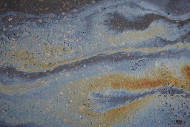 Asfalt Yolu 'ndaki benzin lekelerinin rengi doku ya da arka plan. Asfalt' ta yağ lekesi..