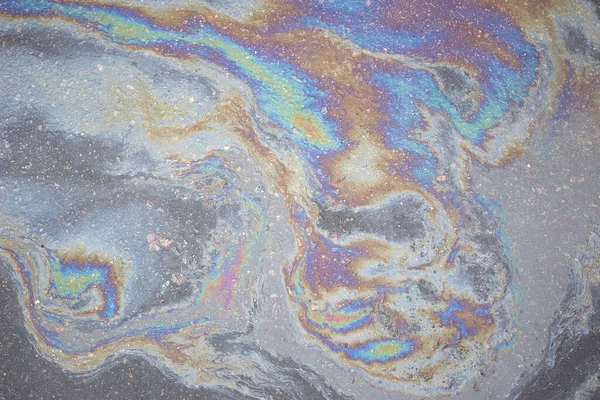 Oil stain on Asphalt, color Gasoline fuel spots on Asphalt Road as Texture or Background