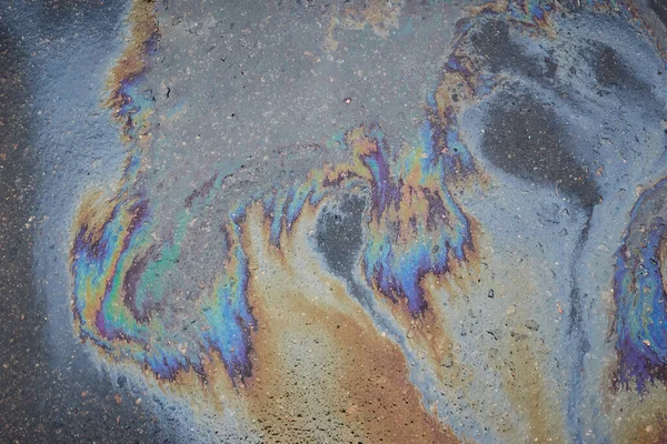 Abstract background with oil stain of oil products.Oil stain on Asphalt, color Gasoline fuel spots on Asphalt Road as Texture or Background.