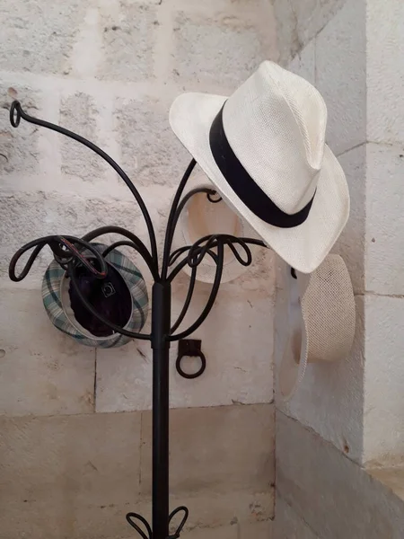 An interesting decoration of a hanger with hats.