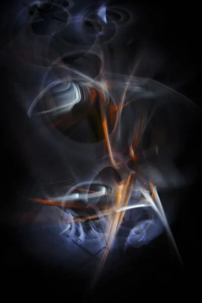 Multicolored abstract image painted by moving light and moving objects on a black background