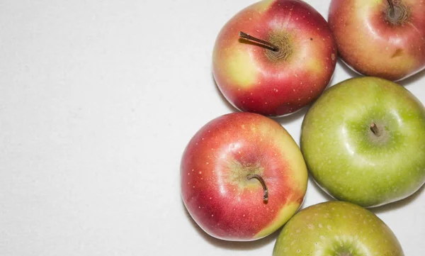 red and green apples on white background