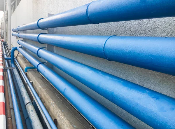 close-up shot of blue pipes on white wall