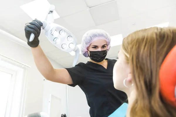 Dental clinic. Reception, examination of the patient. Teeth care. Dentist curing a girl patient — Stock Photo, Image