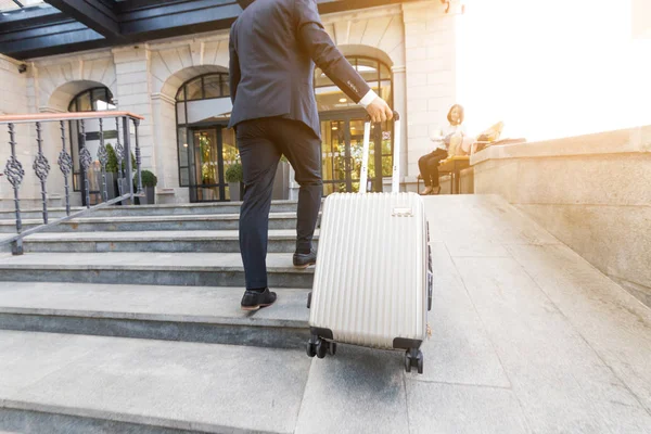 Hombre sosteniendo la maleta. hombre de negocios con equipaje viaja, va a una reunión de negocios — Foto de Stock