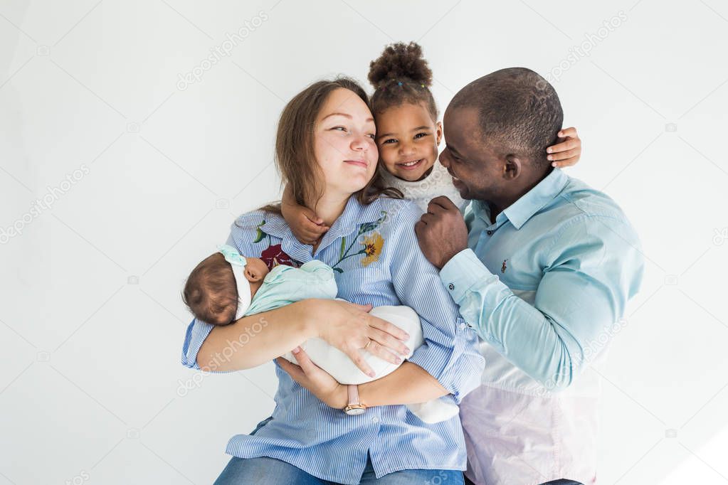Family portrait on a white background. Happy multiethnic family. Family values