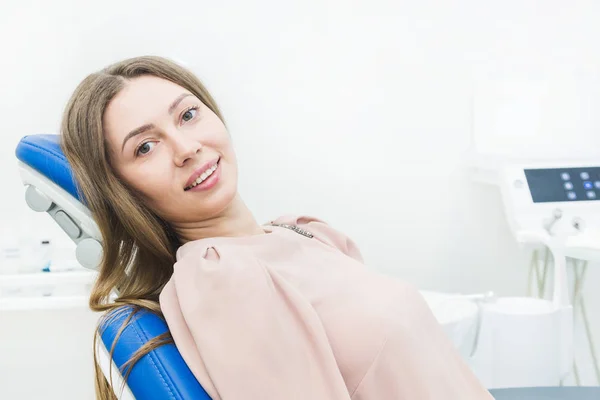 Clínica dental. Recepción, examen del paciente. Cuidado de los dientes. Mujer joven se somete a un examen dental por un dentista — Foto de Stock