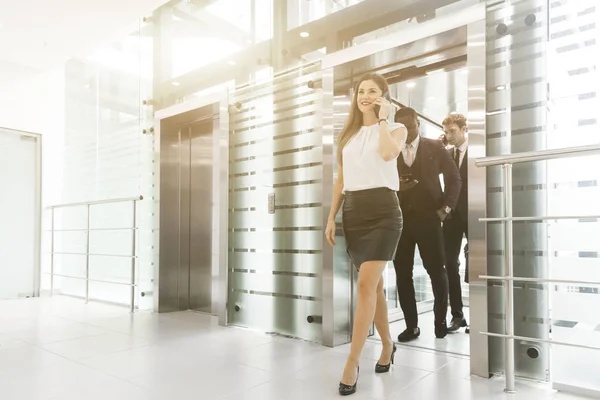 successful and young businessmen in the elevator business center rides to work