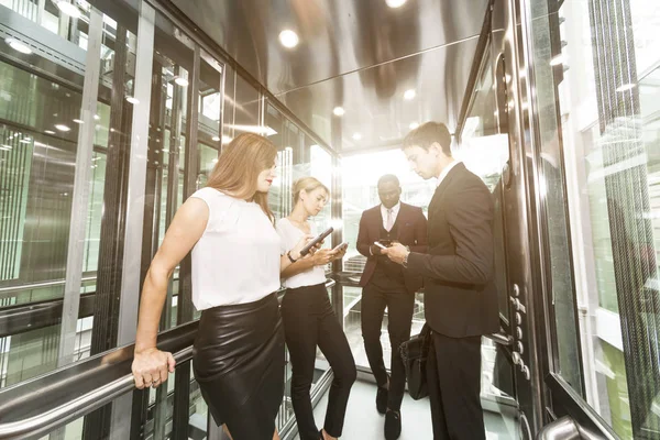 successful and young businessmen in the elevator business center rides to work