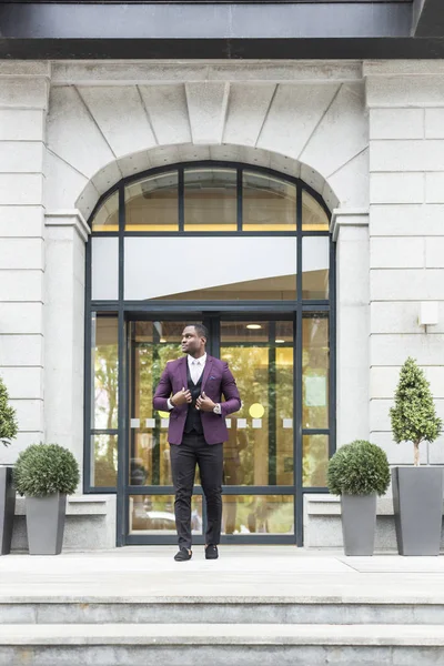 stylish businesswoman with briefcase on city background. African American man talking on mobile phone