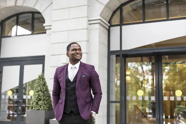 stylish businesswoman with briefcase on city background. African American man talking on mobile phone