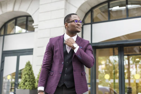 stylish businesswoman with briefcase on city background. African American man talking on mobile phone