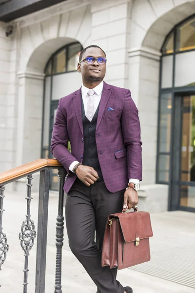 stylish businesswoman with briefcase on city background. African American man talking on mobile phone